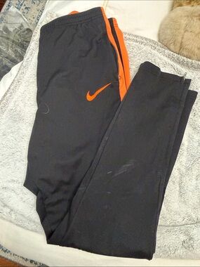 Nike Black Track Pants with Orange Swoosh and Stripe